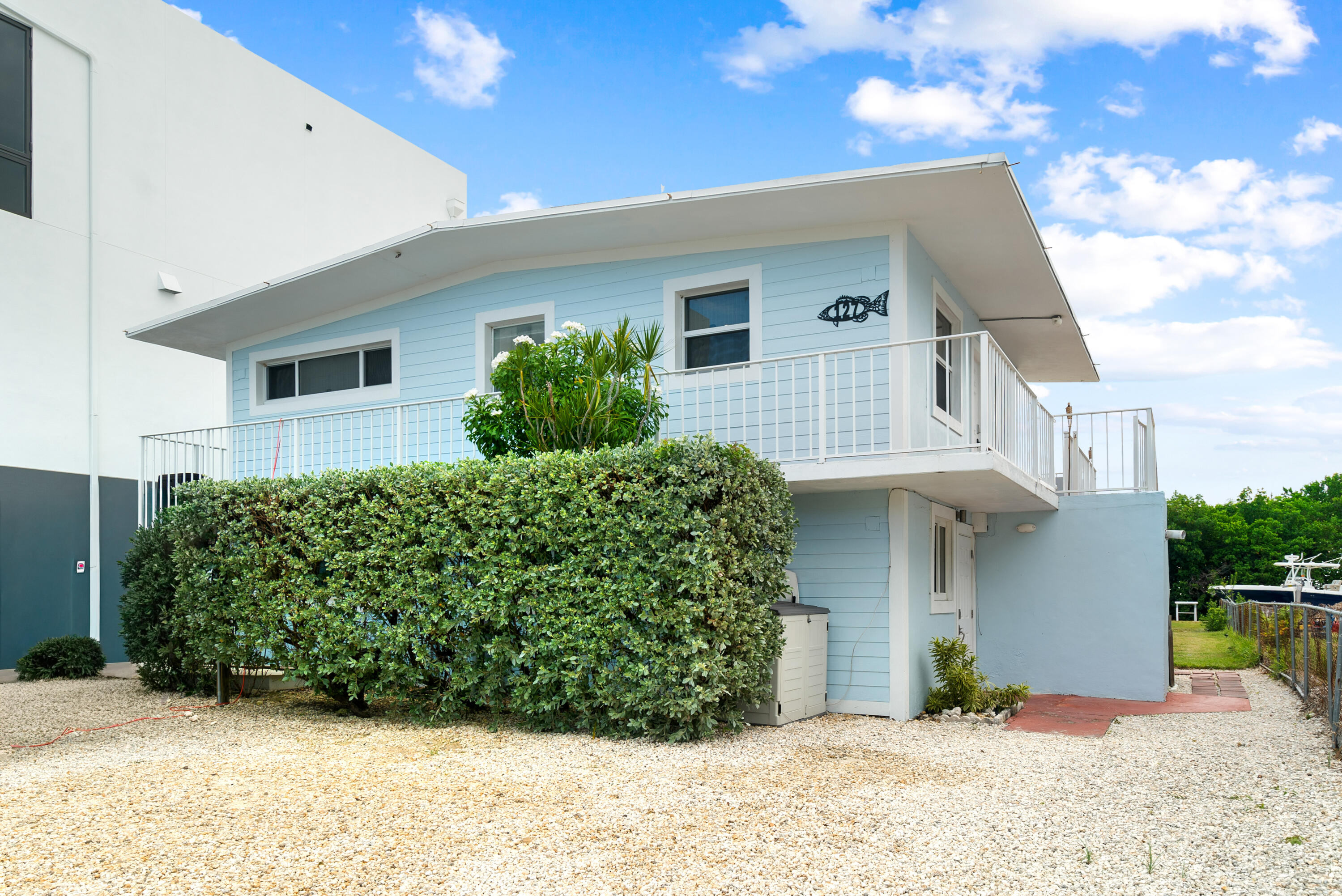 127 Seaside Avenue Key Largo, FL 33037 - Photo 1 of 50 a front view of a house with a yard