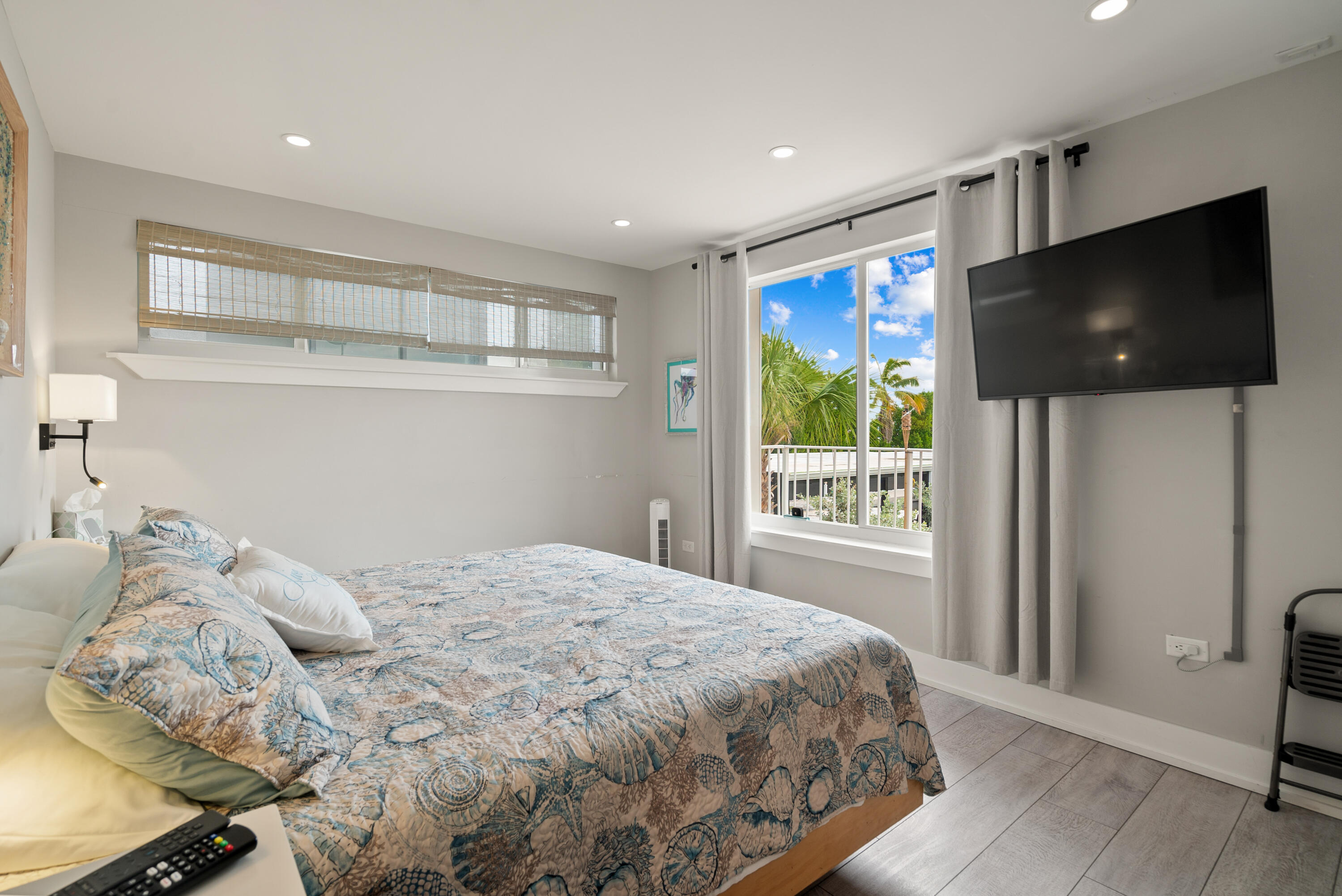 127 Seaside Avenue Key Largo, FL 33037 - Photo 16 of 50 a bedroom with a large bed and a flat screen tv