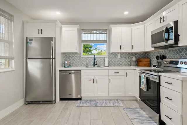 an aerial view of a house with swimming pool and porch