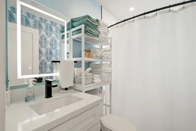 an aerial view of multiple houses with a yard