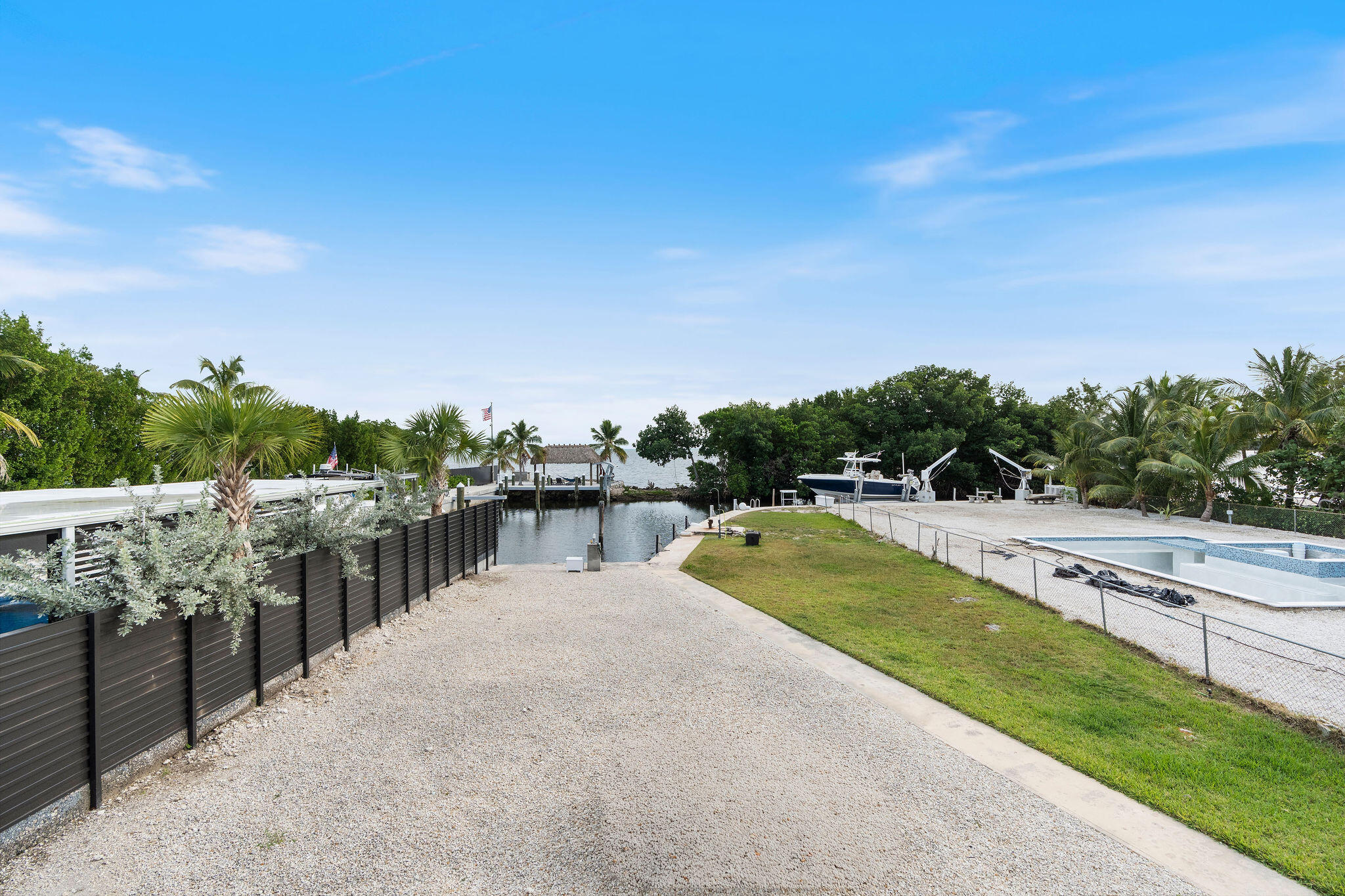 127 Seaside Avenue Key Largo, FL 33037 - Photo 22 of 50 a view of a swimming pool with an outdoor seating and a garden