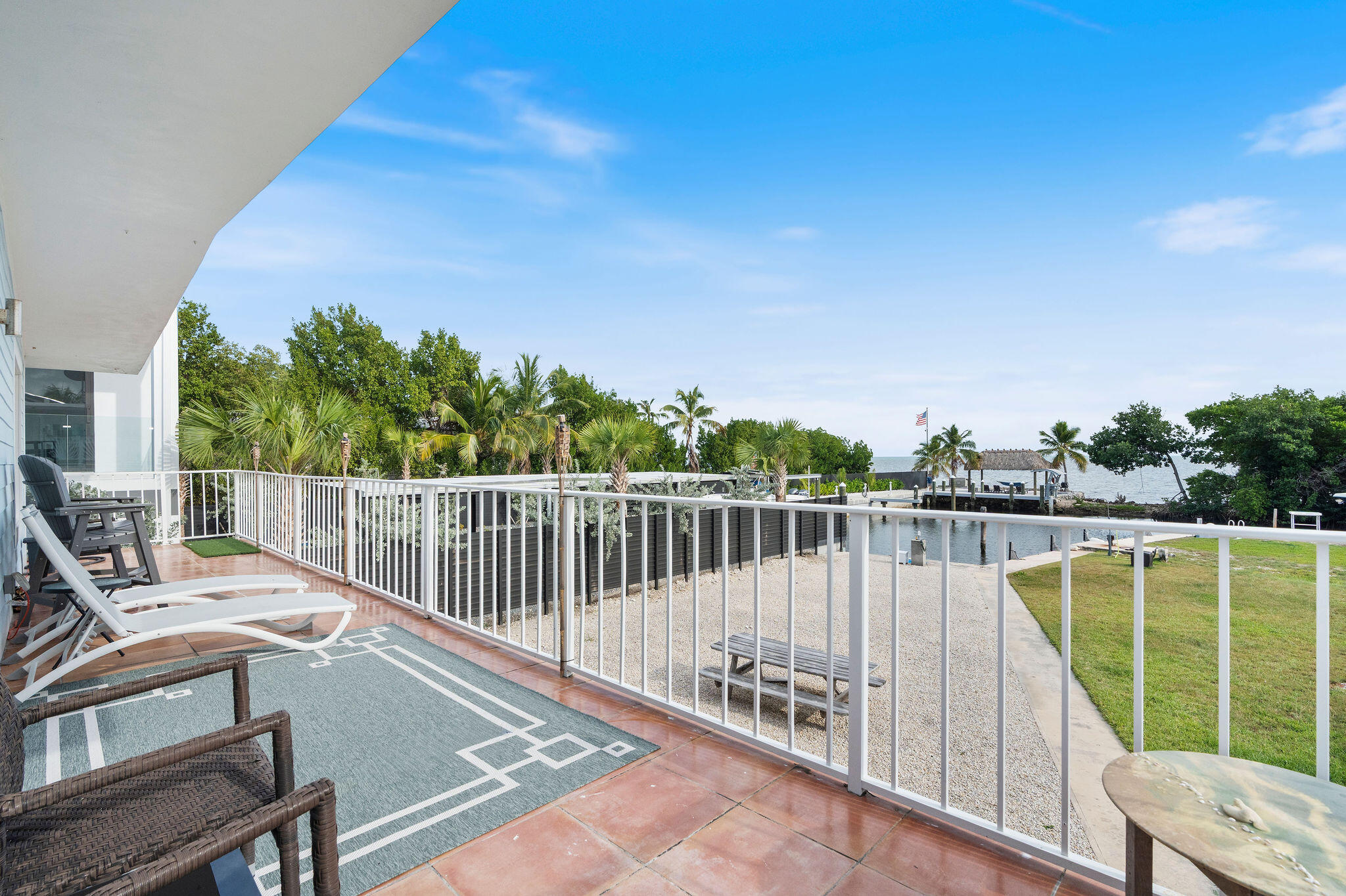 127 Seaside Avenue Key Largo, FL 33037 - Photo 36 of 50 a view of a chair and tables on the roof deck