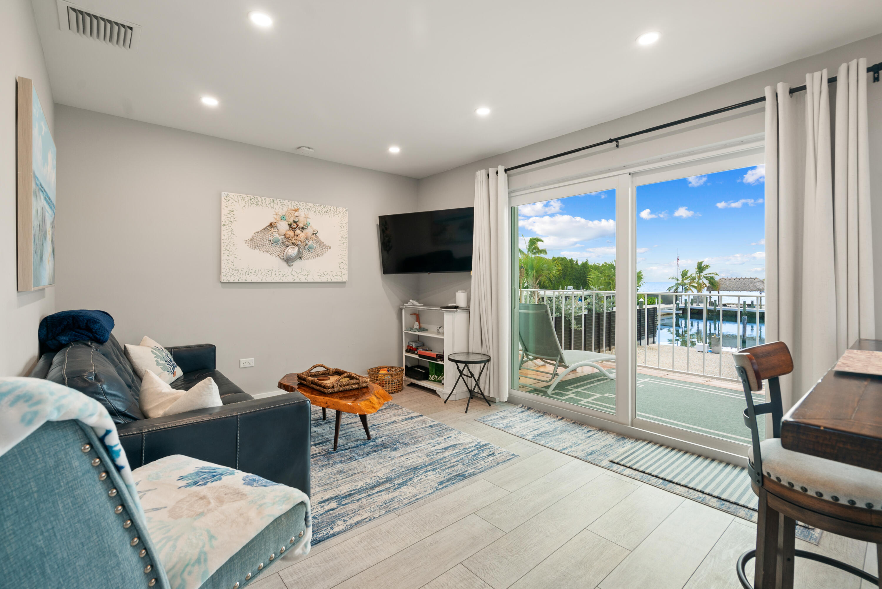 127 Seaside Avenue Key Largo, FL 33037 - Photo 9 of 50 a living room with furniture and a flat screen tv