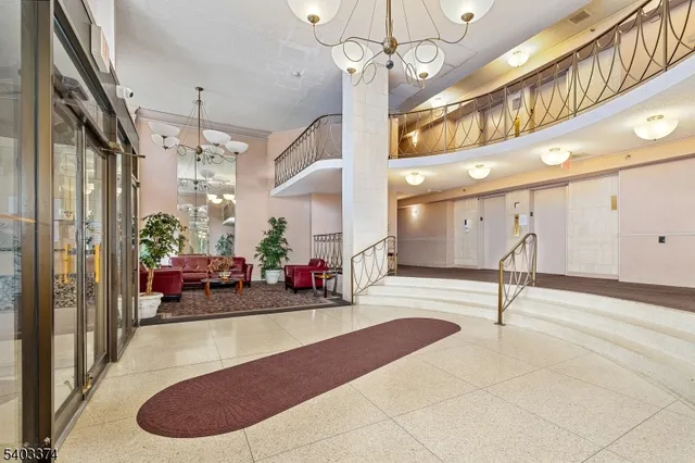a lobby with furniture and a chandelier