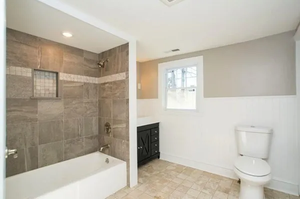a bathroom with a bathtub and toilet