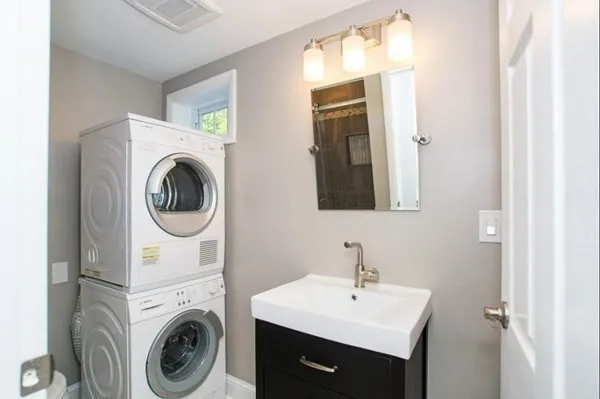 a view of a bathroom with washing machine and sink