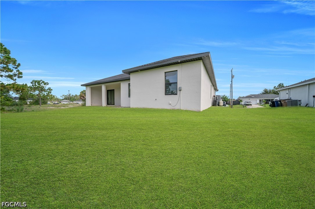 3509 38th Street Southwest Lehigh Acres, FL 33976 - Photo 35 of 47 a house with a yard