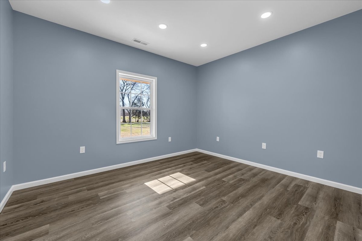 191 Tiffany Lane Decherd, TN 37324 - Photo 15 of 37 a view of empty room with wooden floor and fan
