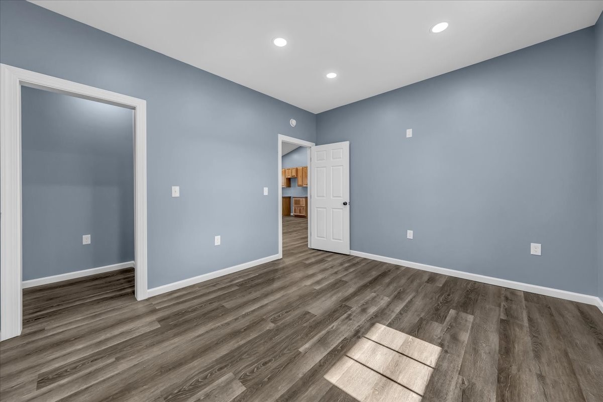 191 Tiffany Lane Decherd, TN 37324 - Photo 16 of 37 an empty room with wooden floor and natural light