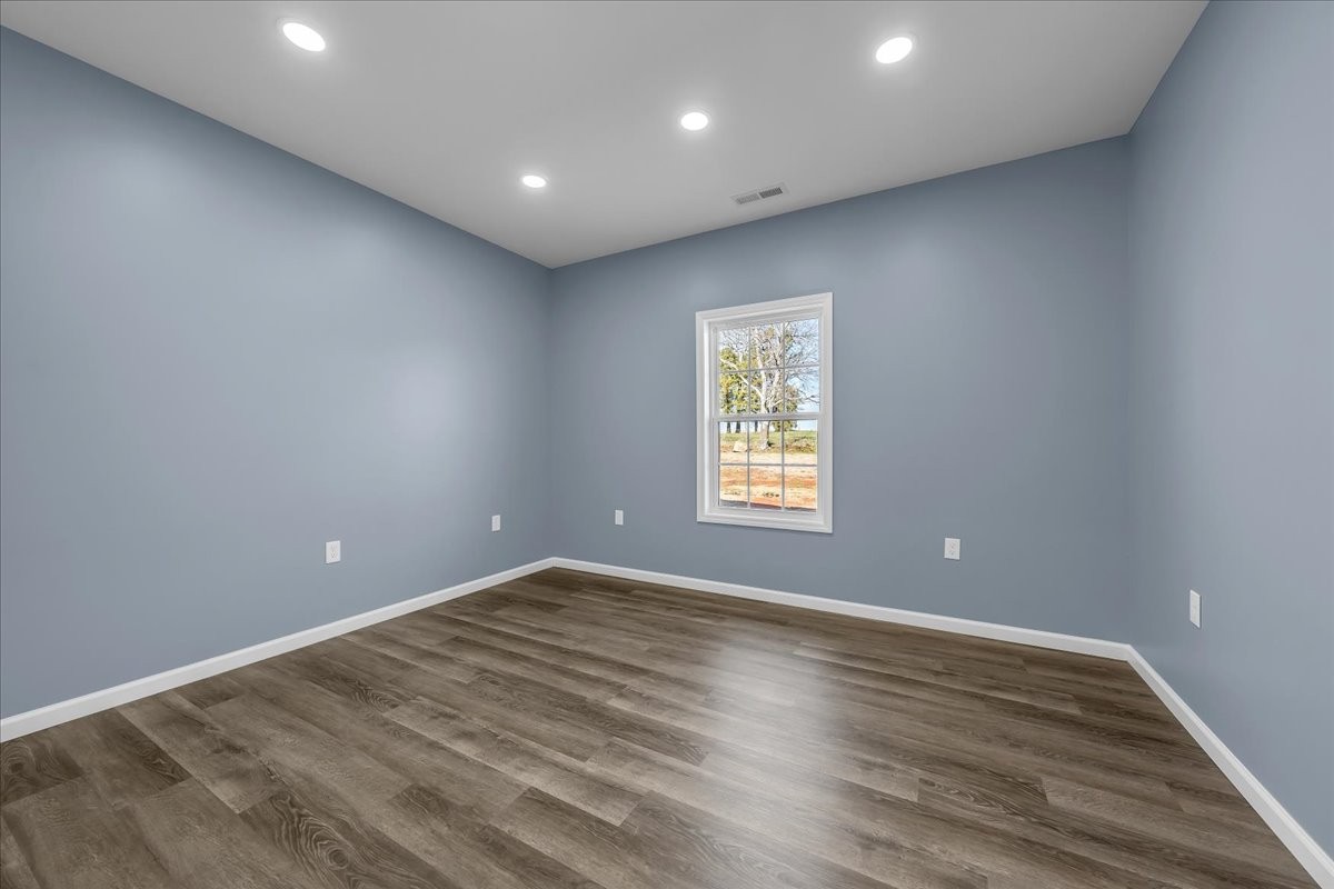 191 Tiffany Lane Decherd, TN 37324 - Photo 19 of 37 an empty room with wooden floor and windows