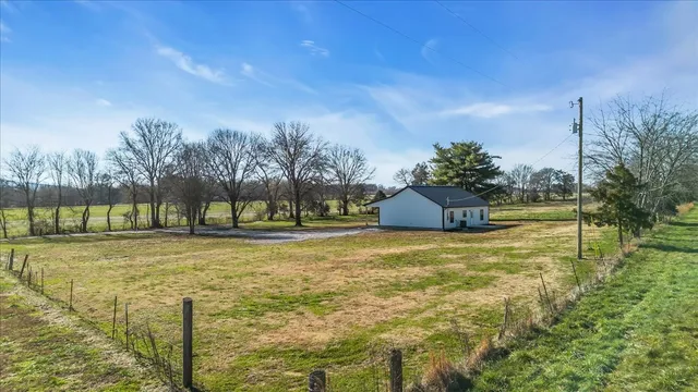 a view of a yard with a house in the background