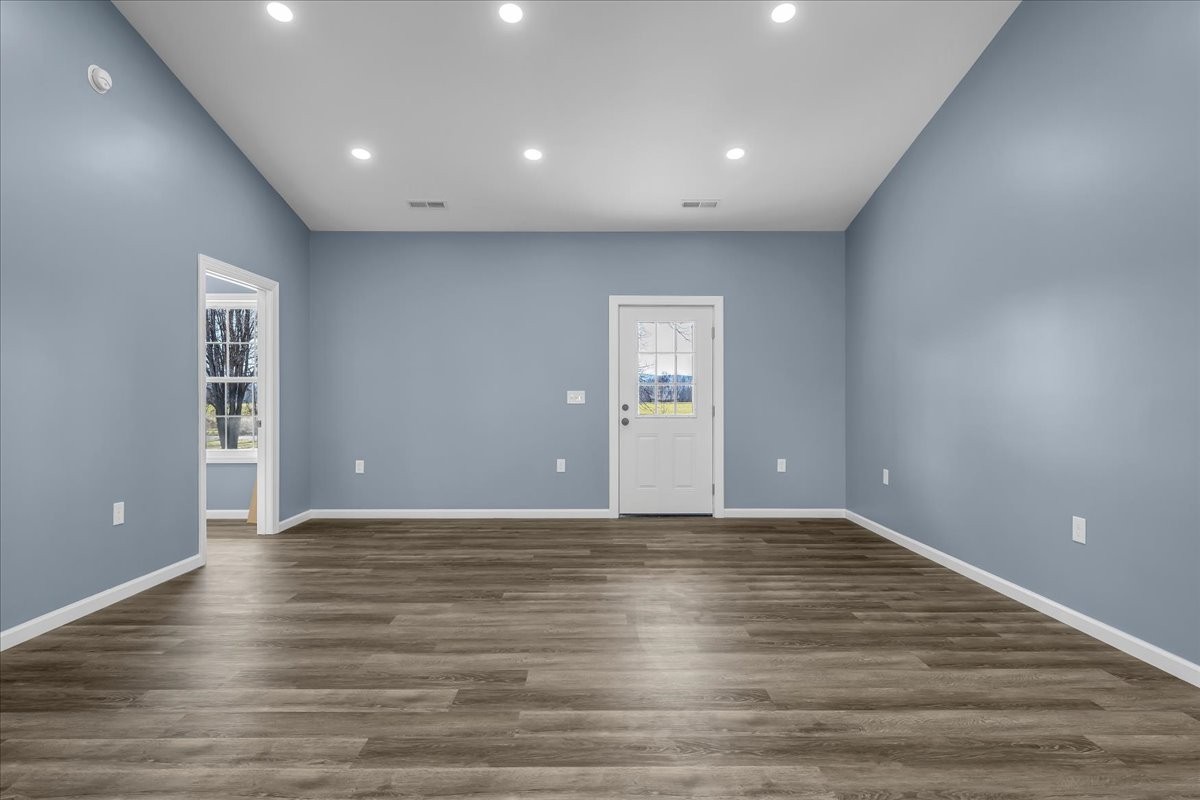 191 Tiffany Lane Decherd, TN 37324 - Photo 5 of 37 a view of an empty room with wooden floor and windows