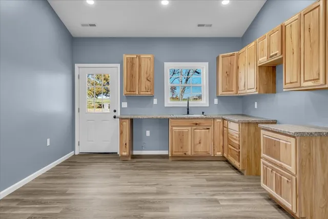 a kitchen with granite countertop a sink and cabinets