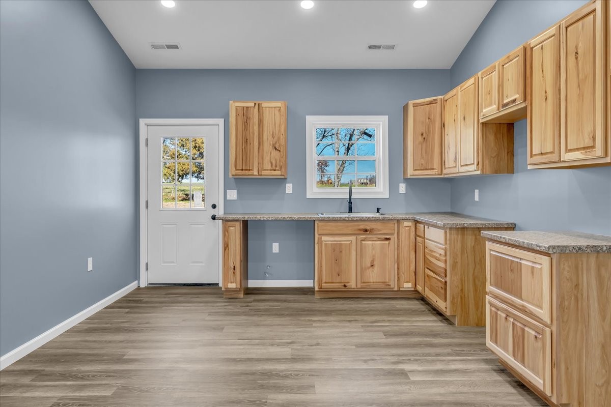 191 Tiffany Lane Decherd, TN 37324 - Photo 8 of 37 a kitchen with stainless steel appliances granite countertop a sink and cabinets with wooden floor
