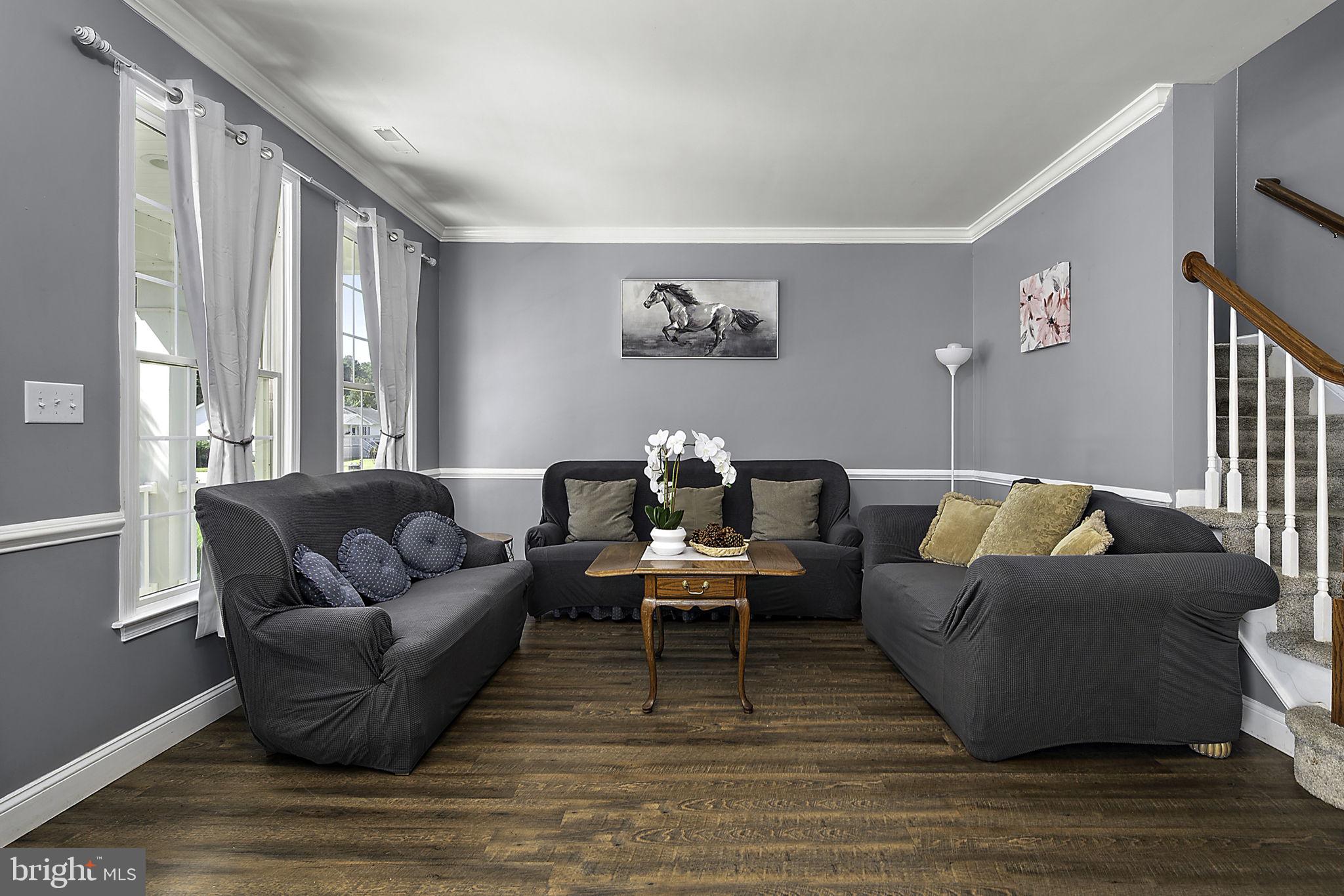 12167 Snug Harbor Road Berlin, MD 21811 - Photo 12 of 107 a living room with furniture and a wooden floor