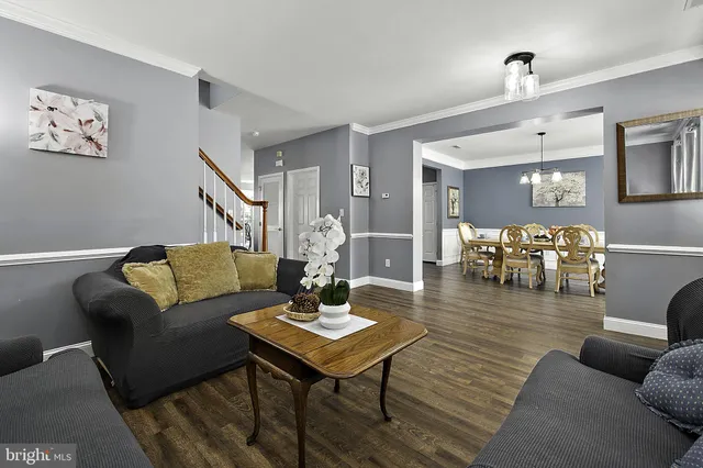 a living room with furniture a table and a fireplace