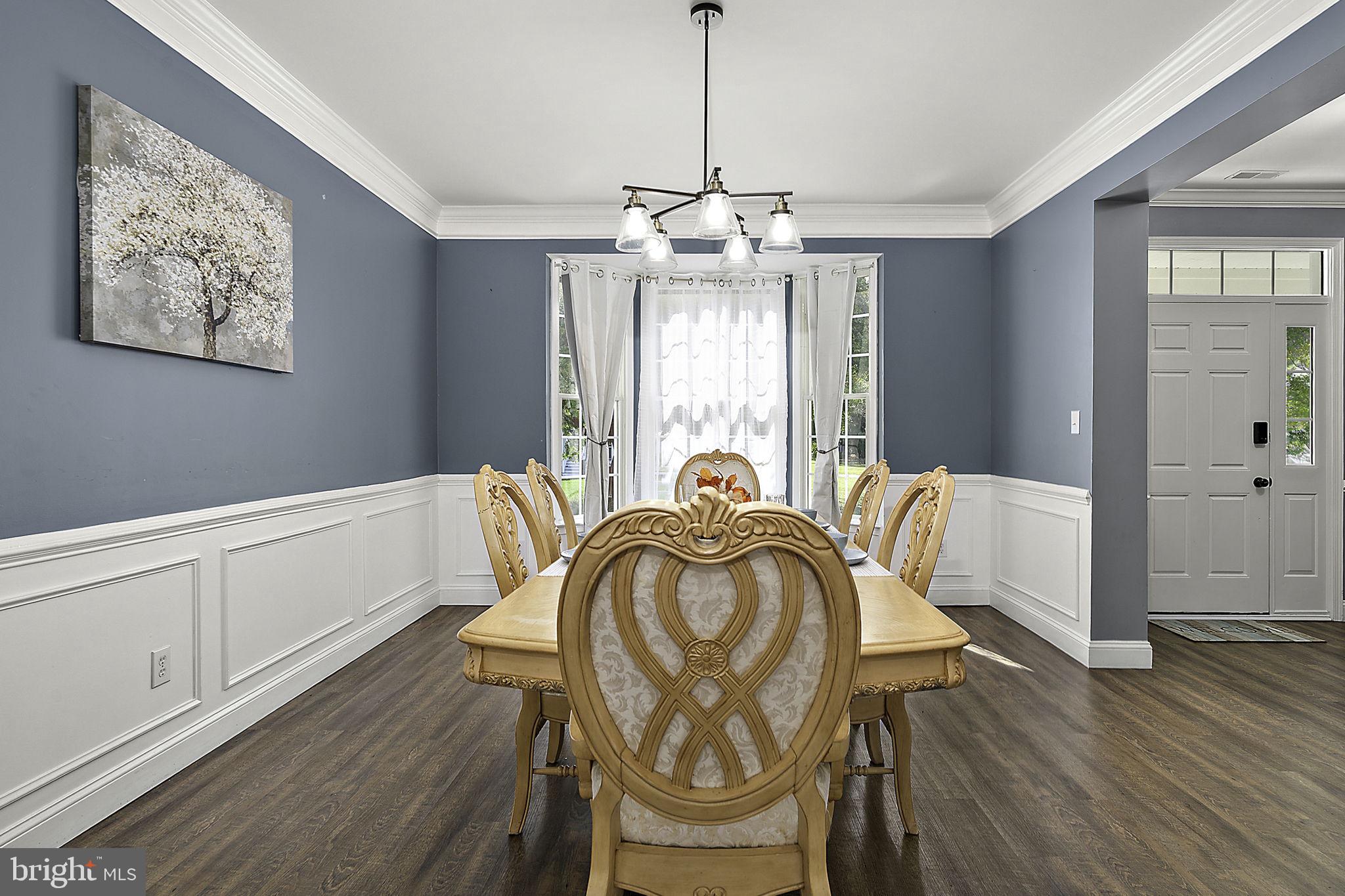 12167 Snug Harbor Road Berlin, MD 21811 - Photo 16 of 107 a view of a dining room with furniture window and wooden floor