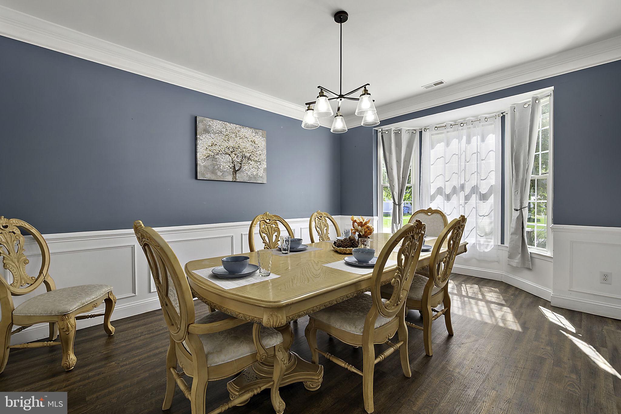 12167 Snug Harbor Road Berlin, MD 21811 - Photo 16 of 107 a view of a dining room with furniture window and wooden floor