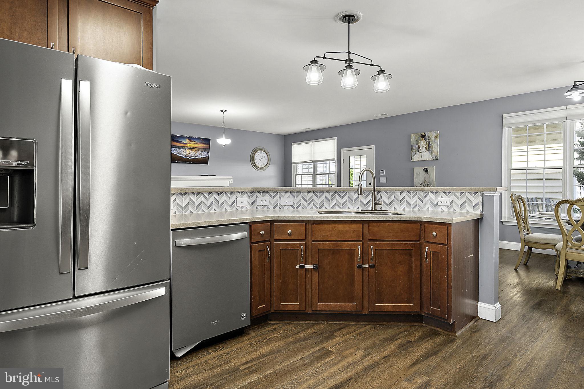 12167 Snug Harbor Road Berlin, MD 21811 - Photo 27 of 107 a spacious bathroom with a granite countertop sink and a refrigerator