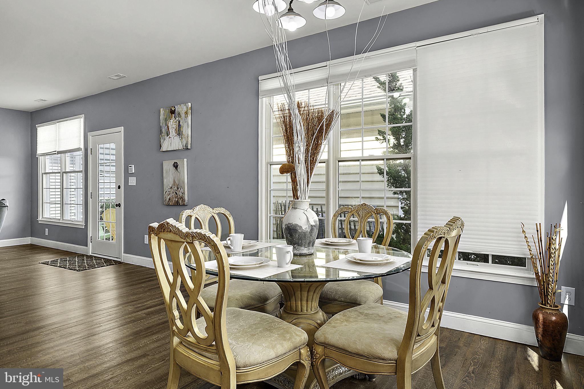 12167 Snug Harbor Road Berlin, MD 21811 - Photo 33 of 107 a dining room with furniture wooden floor and a chandelier