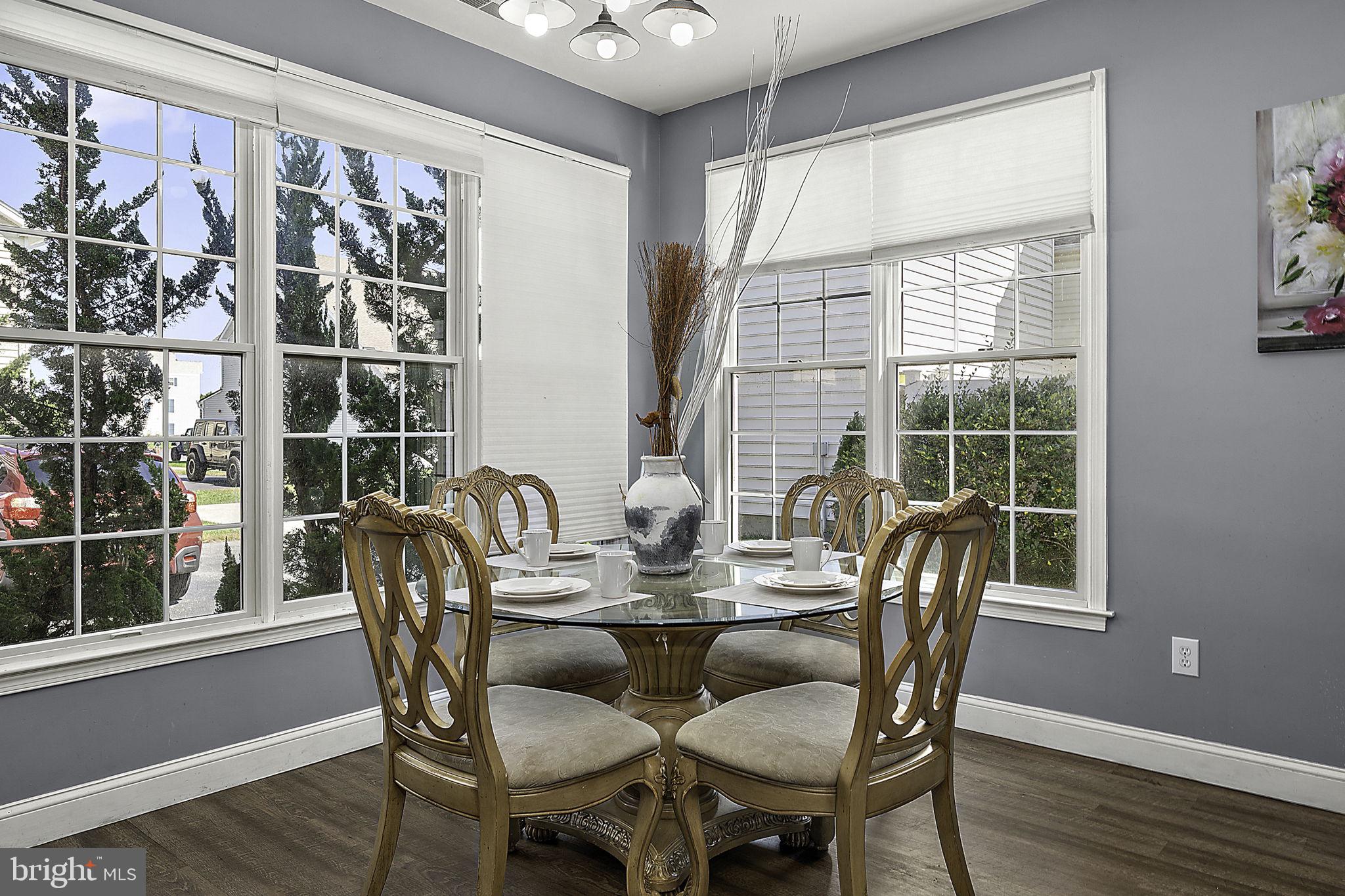 12167 Snug Harbor Road Berlin, MD 21811 - Photo 34 of 107 a view of a dining room with furniture window and wooden floor