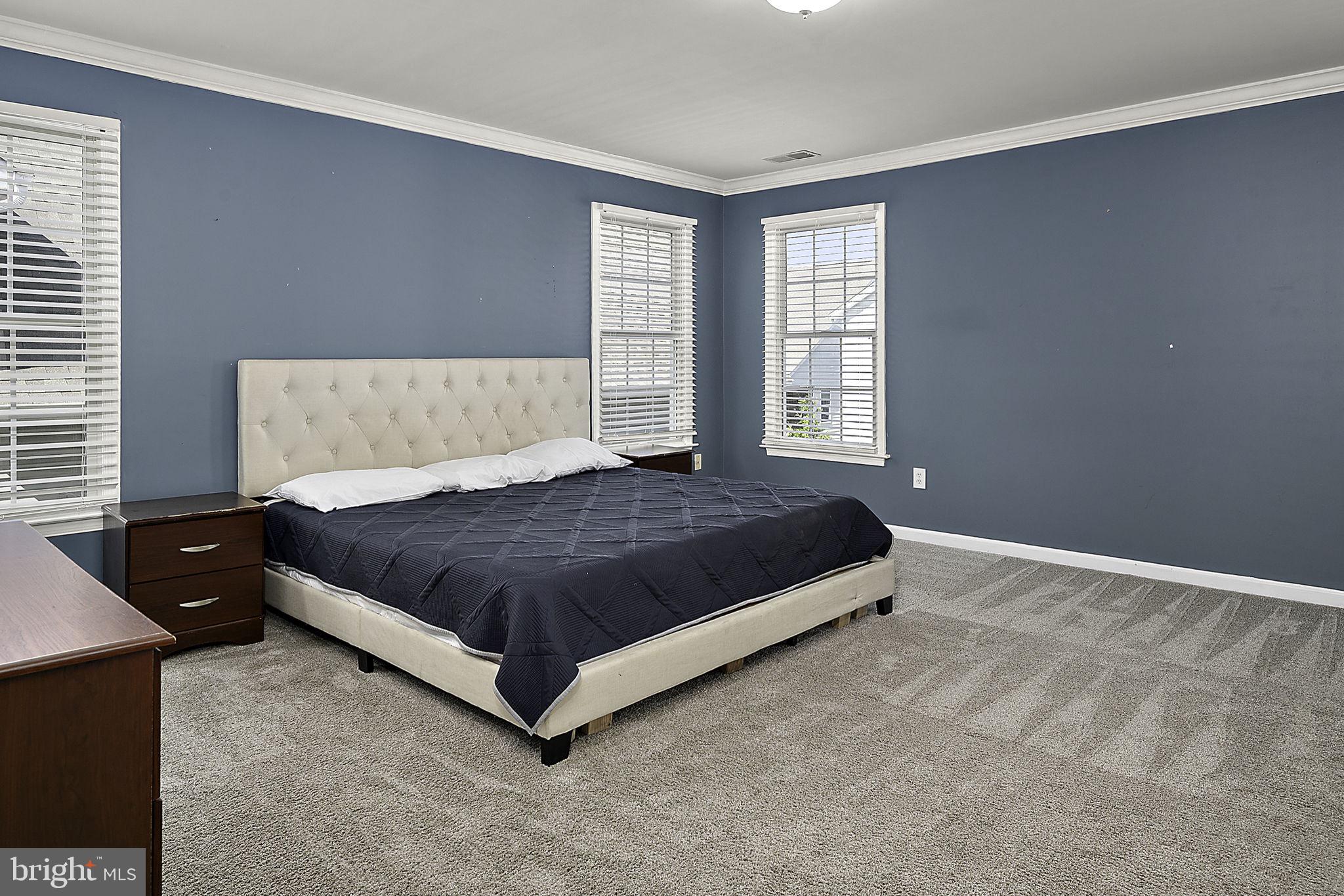 12167 Snug Harbor Road Berlin, MD 21811 - Photo 36 of 107 a large bed sitting in a bedroom next to a window