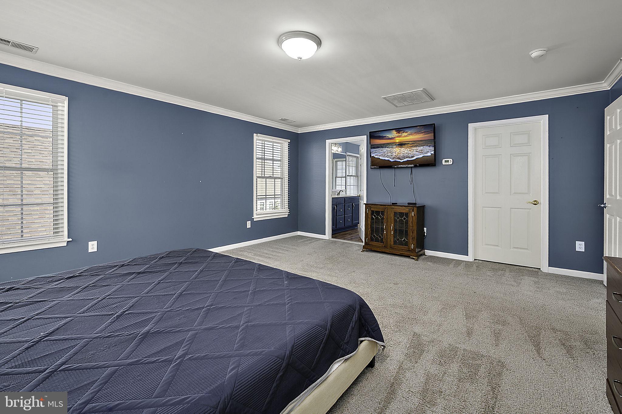 12167 Snug Harbor Road Berlin, MD 21811 - Photo 37 of 107 a bedroom with a bed and a large window