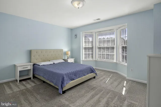 an aerial view of residential houses with outdoor space and swimming pool