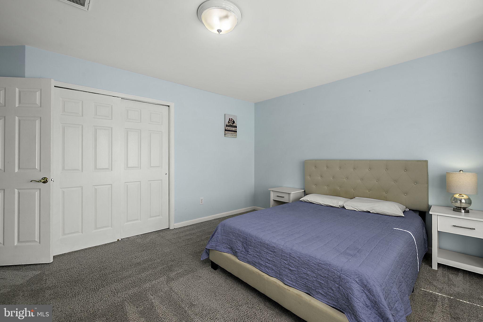 12167 Snug Harbor Road Berlin, MD 21811 - Photo 44 of 107 a bedroom with a bed and a night lamp
