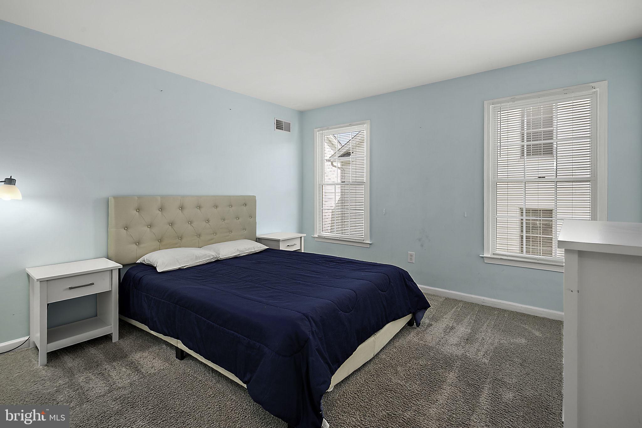 12167 Snug Harbor Road Berlin, MD 21811 - Photo 48 of 107 a bedroom with a bed and windows