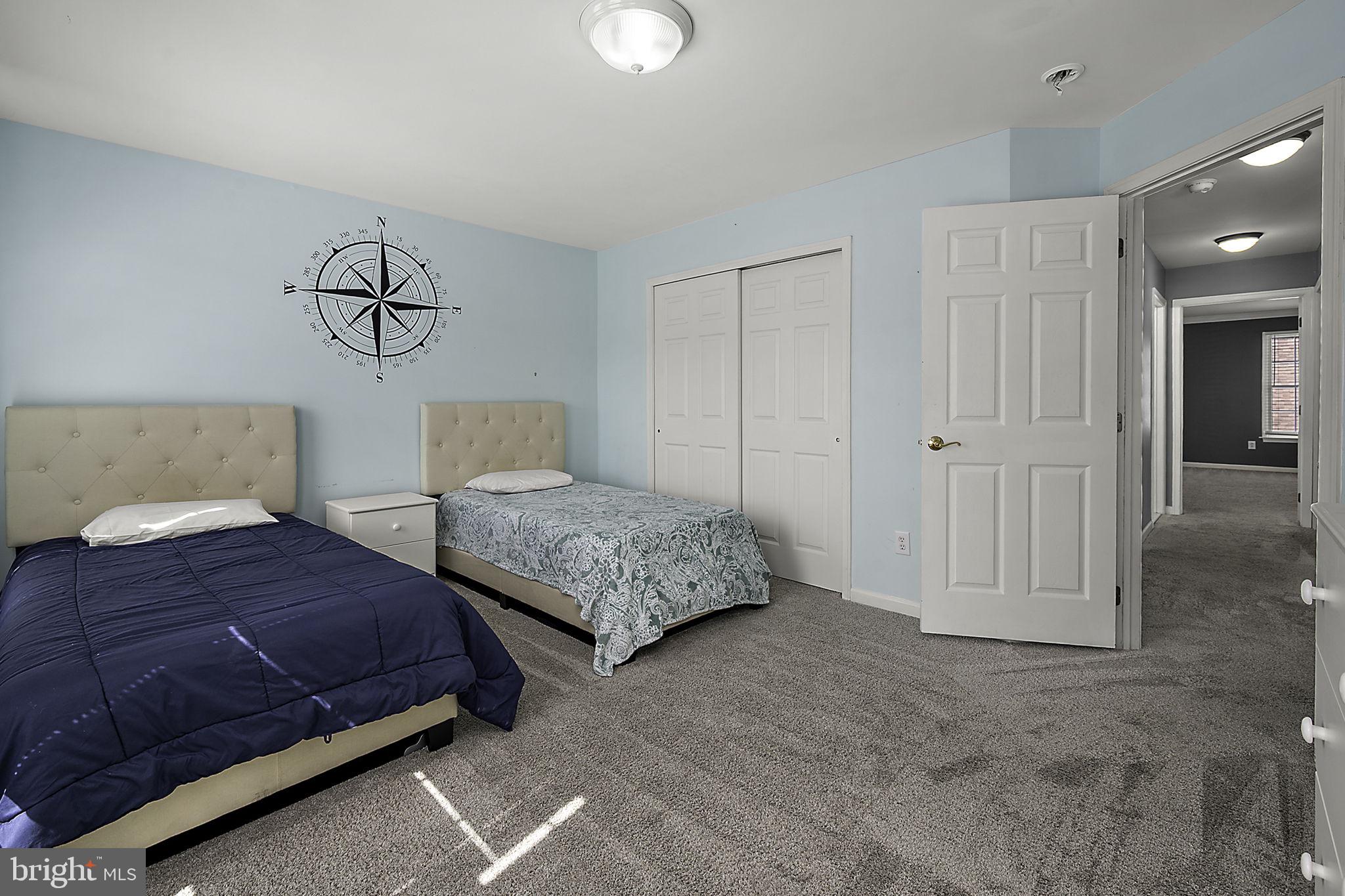 12167 Snug Harbor Road Berlin, MD 21811 - Photo 52 of 107 a bedroom with a bed and a chandelier