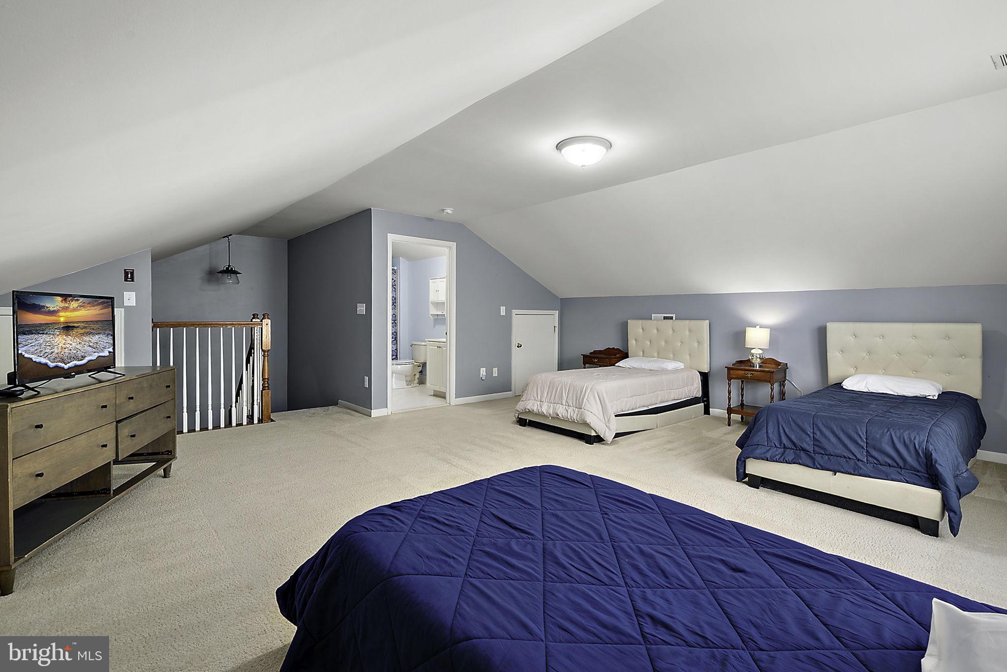 12167 Snug Harbor Road Berlin, MD 21811 - Photo 59 of 107 a spacious bedroom with two beds and a couch