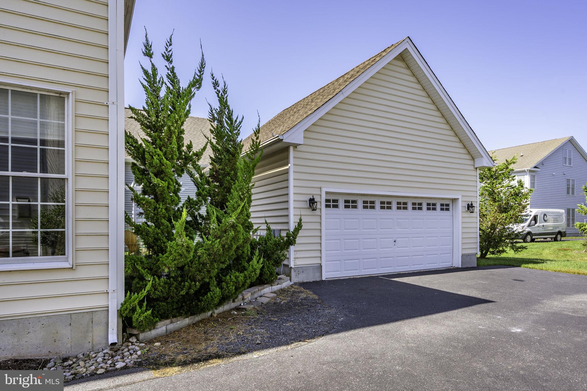 12167 Snug Harbor Road Berlin, MD 21811 - Photo 68 of 107 a front view of a house with a yard and garage
