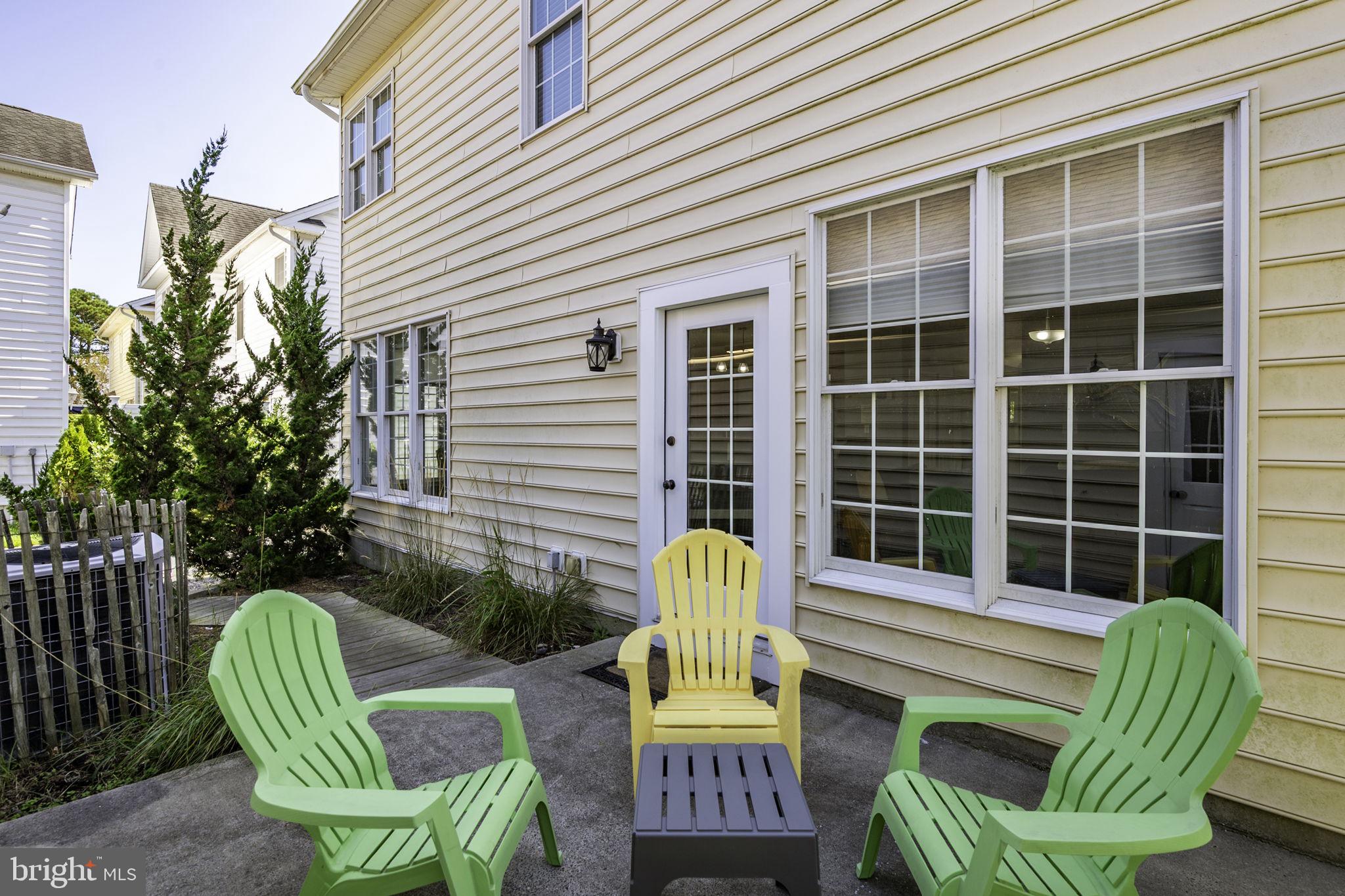 12167 Snug Harbor Road Berlin, MD 21811 - Photo 70 of 107 a view of a chair and tables in the back yard of a house