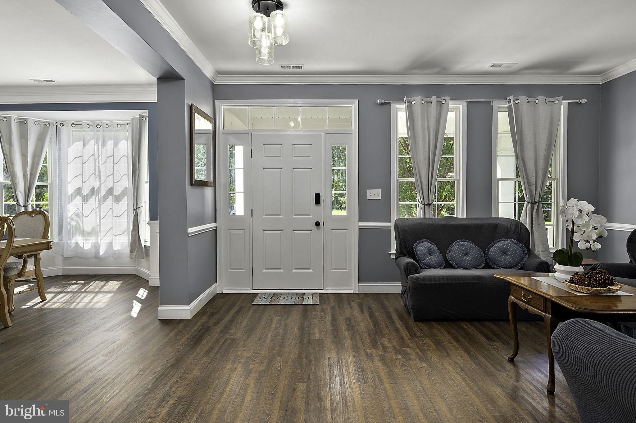12167 Snug Harbor Road Berlin, MD 21811 - Photo 10 of 107 a living room with furniture and a large window