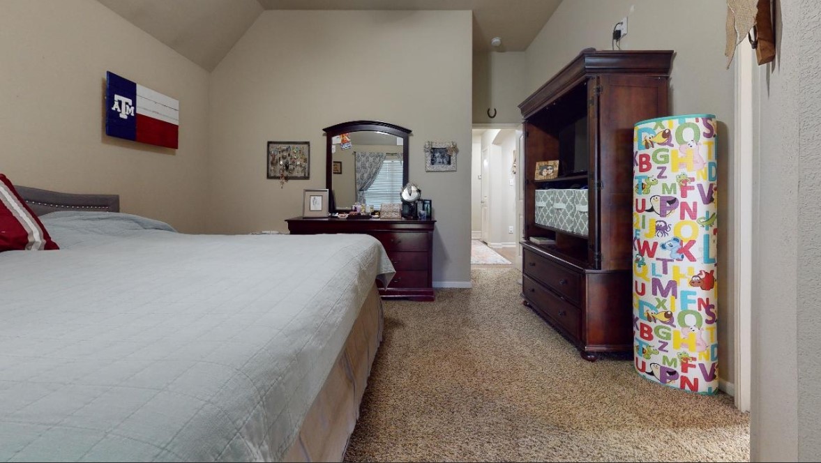 2015 Positano Loop Bryan, TX 77808 - Photo 11 of 15 a bedroom with bed and a desk