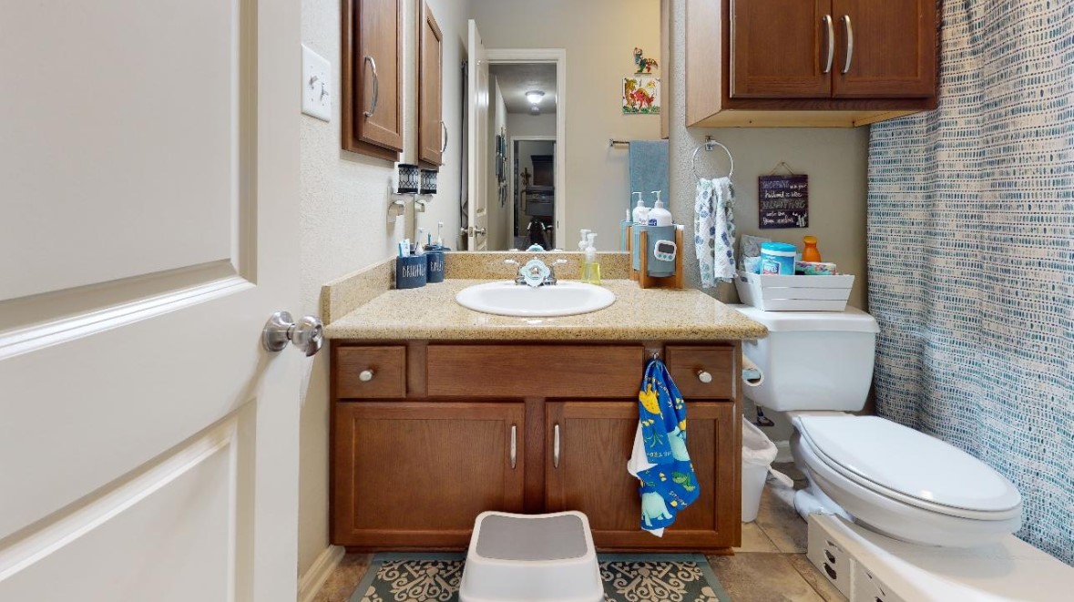 2015 Positano Loop Bryan, TX 77808 - Photo 12 of 15 a bathroom with a sink toilet and mirror