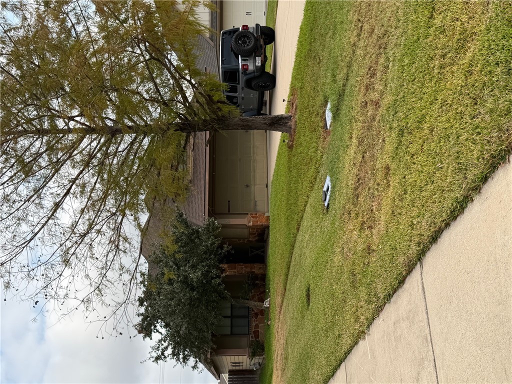 2015 Positano Loop Bryan, TX 77808 - Photo 14 of 15 a view of a house with a yard