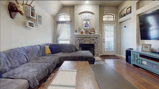 a kitchen with stainless steel appliances granite countertop a stove a sink dishwasher and microwave with wooden floor