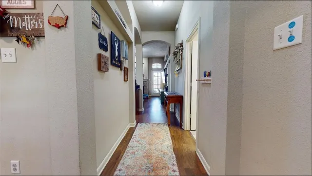 a kitchen with a refrigerator and a stove top oven