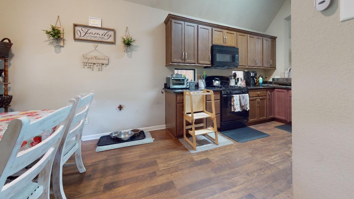 2015 Positano Loop Bryan, TX 77808 - Photo 5 of 15 a kitchen with a refrigerator and a stove top oven