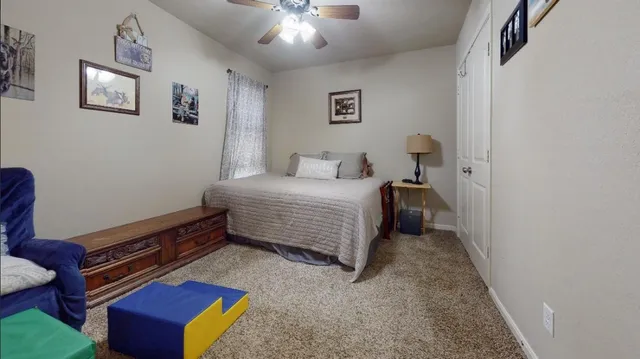 a bedroom with a bed and a window