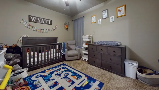 a bedroom with bed and a desk