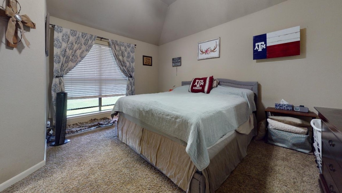 2015 Positano Loop Bryan, TX 77808 - Photo 10 of 15 a bedroom with a bed and a window