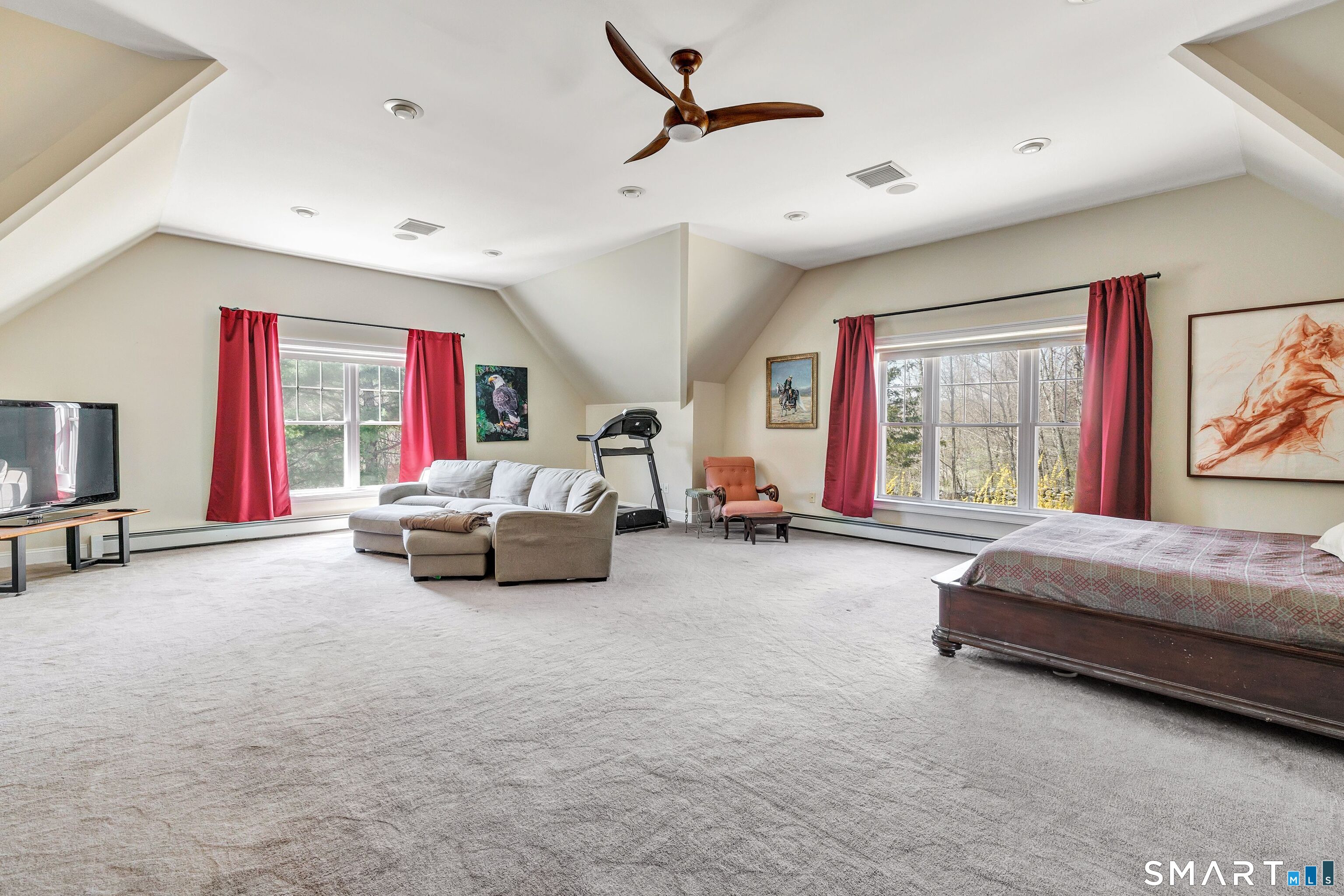 25 Starrs Ridge Road Redding, CT 06896 - Photo 19 of 38 Impressive primary bedroom suite with a vaulted ceiling, expansive walk-in closet, spa-inspired bath with steam shower, and stunning views of the pond.