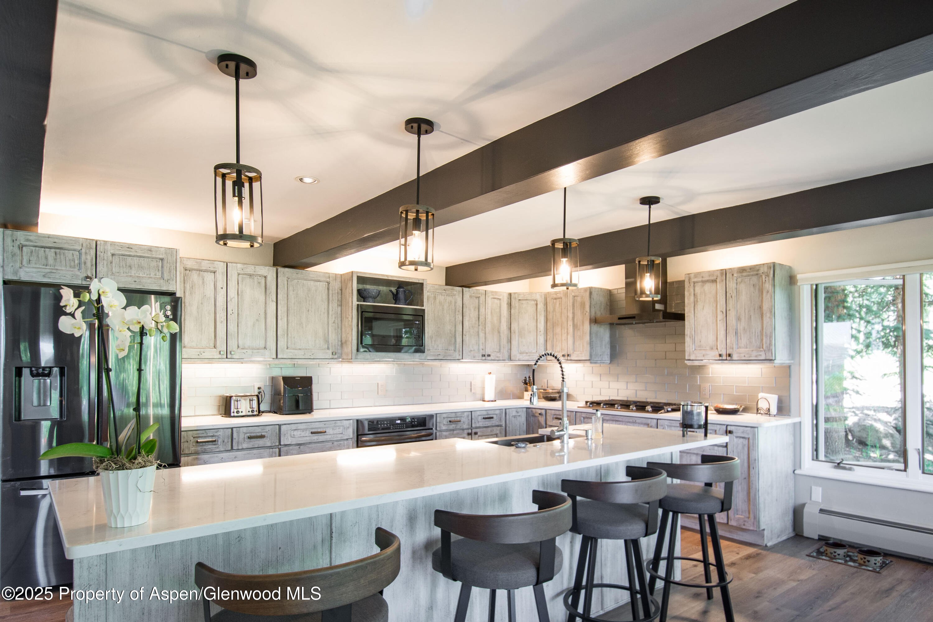 215 Maple Ridge Lane Snowmass Village, CO 81615 - Photo 7 of 30 a large kitchen with lots of counter space and windows