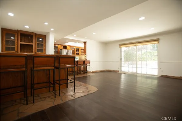 a view of a work space with furniture and wooden floor