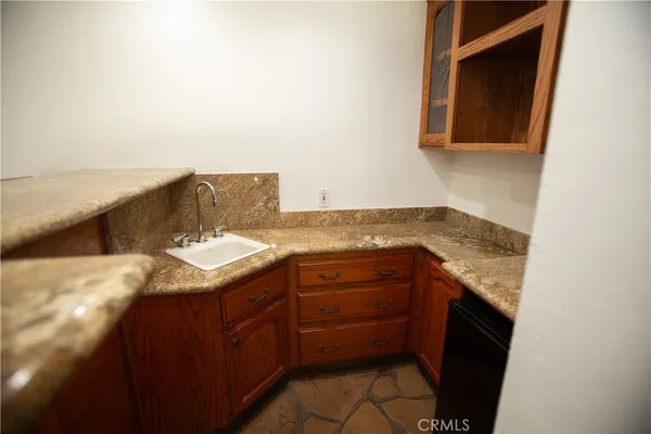 a bathroom with a granite countertop sink and a vanity