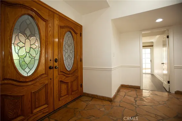 a view of an entryway with wooden floor