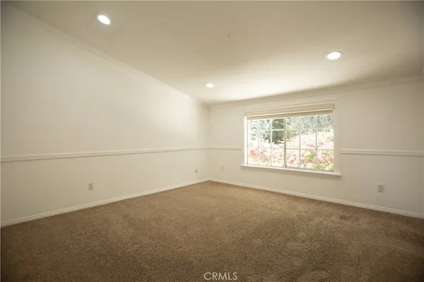 an empty room with a empty space and windows